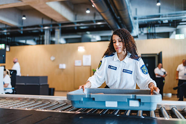 istock Focused Young Hispanic Female Airport Security Worker Operating Baggage Screening System Indoors 2243744271