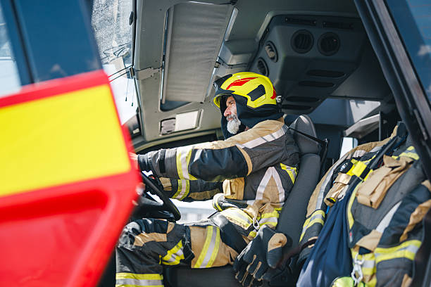 istock Engaged Airport Firefighter Maneuvering Cockpit Controls in Advanced Fire Truck 2243744965