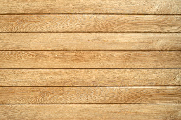 istock New light brown vinyl siding in wood style on wall closeup 2243745189