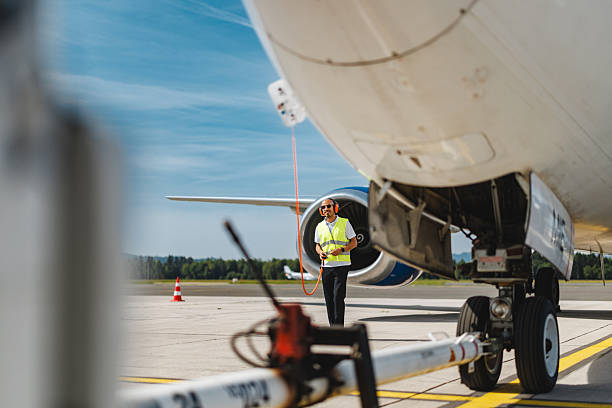 istock Delighted Technician Conducting Aircraft Systems Check on Sunny Airport Tarmac 2243745278