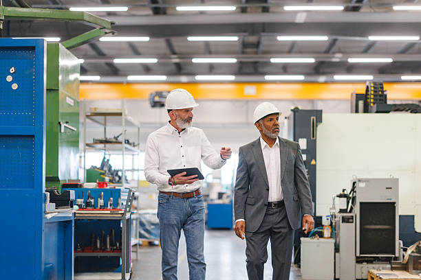 istock Engaged Mature Caucasian Engineer and Hispanic Manager Collaborating in Modern Industrial Factory 2243745401