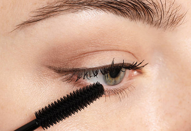 istock Woman applying mascara onto her eyelashes, closeup 2243745543