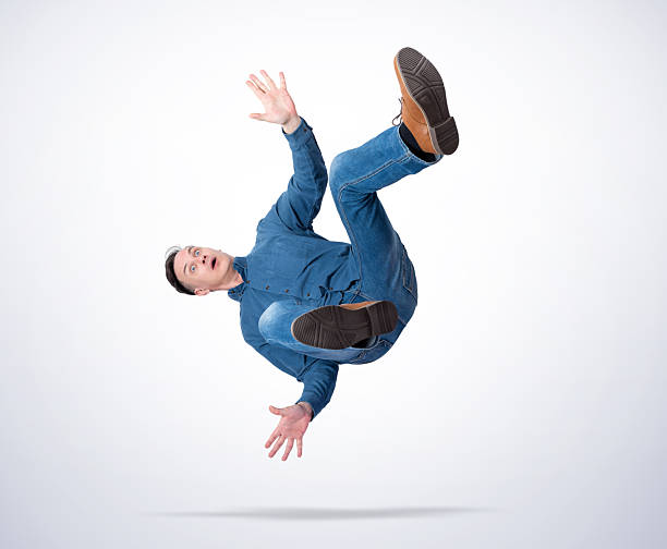 istock Surprised man in casual clothes falling down with arms spread, isolated on light gradient background, concept of failure, accident, shock, losing balance, or business risk 2243747133