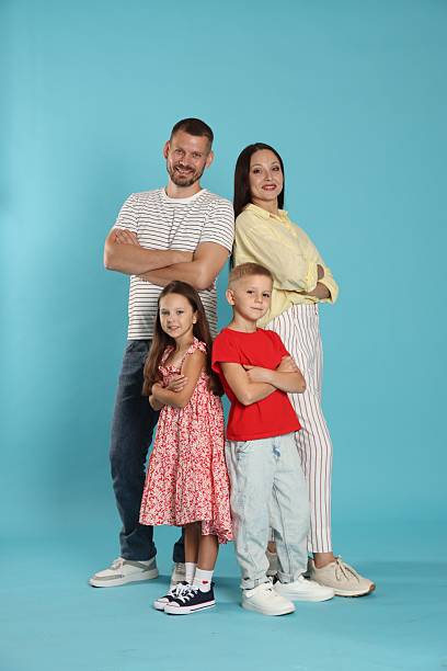 istock Lovely family posing together on light blue background 2243747463