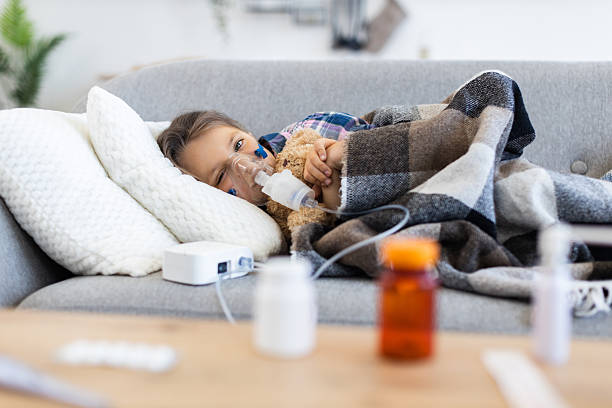 istock Child receiving nebulizer treatment at home 2243748944