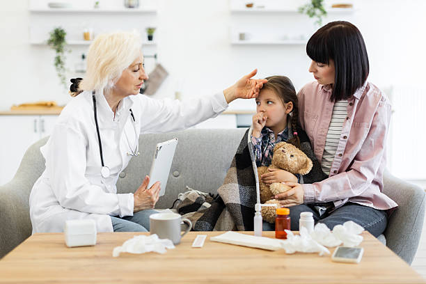 istock Doctor examining a sick child with mother's support at home 2243749022