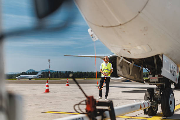 istock Concentrated Technician Engaging in Aircraft Systems Check on Busy Airport Tarmac 2243753350