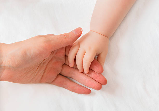 istock baby and mother's hand 2243754263