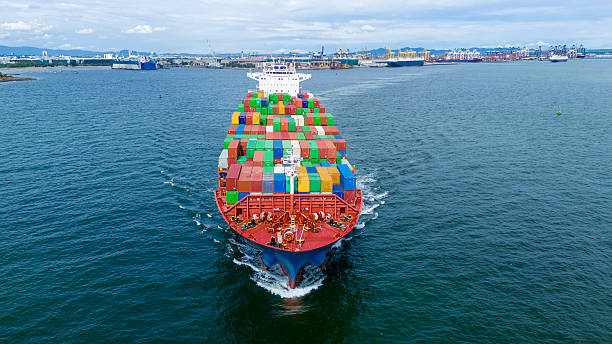istock Aerial view of container cargo ship sailing through deep blue ocean, leaving waves behind. Perfect for concepts of maritime logistics, global shipping, export-import trade, and sea freight transport. 2243754641