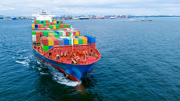 istock Aerial view of container cargo ship sailing through deep blue ocean, leaving waves behind. Perfect for concepts of maritime logistics, global shipping, export-import trade, and sea freight transport. 2243754746