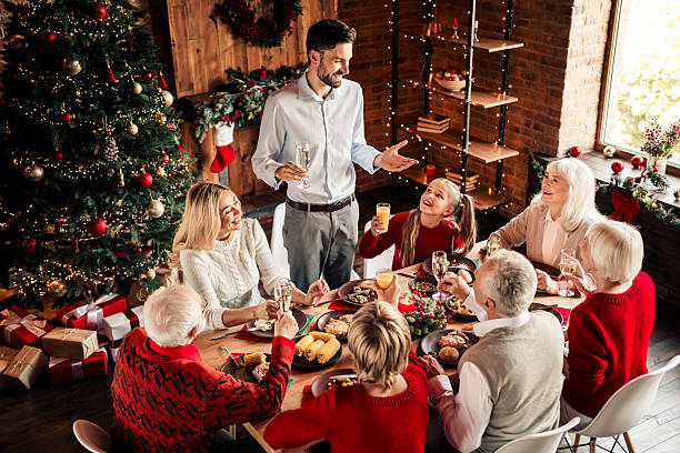 istock Family gathers for Christmas dinner by a decorated tree in a cozy home setting with lights and smiles 2243754899