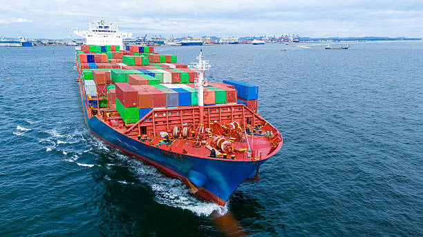 istock Aerial view of container cargo ship sailing through deep blue ocean, leaving waves behind. Perfect for concepts of maritime logistics, global shipping, export-import trade, and sea freight transport. 2243755280