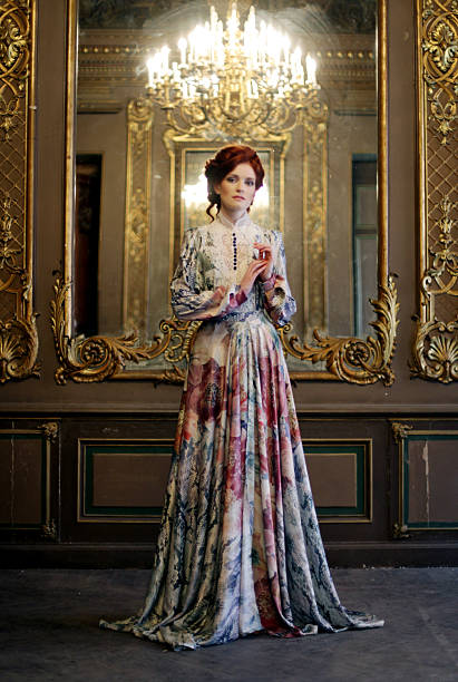 istock woman standing in the palace room with mirror. 2243761509