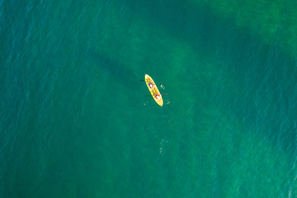 istock Two people kayaking on clear turquoise ocean water 2243762145