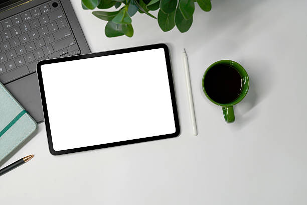 istock Top view office table desk with tablet, coffee, pen, leaves with copy space background 2243763401