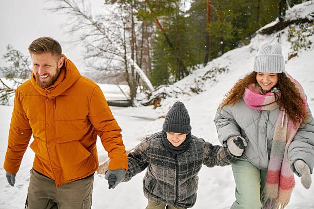 istock Caucasian Family Walking Together Outdoors during Winter Snowfall 2243765840