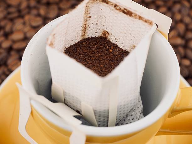 istock Drip bag coffee in a yellow coffee cup 2243767130