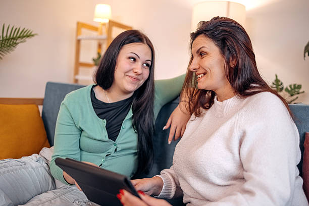 istock Mother and her adult daughter spending time at home using wireless technology 2243768129