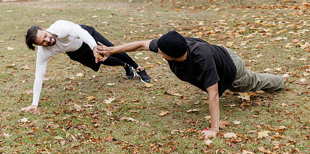 Pushup, training and black man at a fitness bootcamp for exercise, workout and sports. Strong, bodybuilder and athlete doing a cardio challenge, physical activity and strength routine on a field