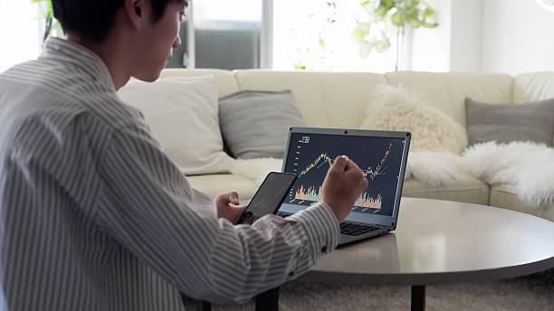 istock Asian man rejoicing at rising stock prices 2243770084