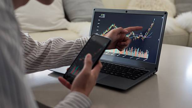 istock Asian man rejoicing at rising stock prices 2243770088