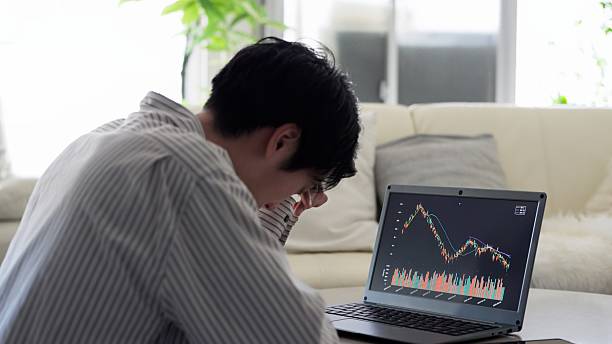 istock Asian man feeling depressed after seeing stock prices fall 2243770092
