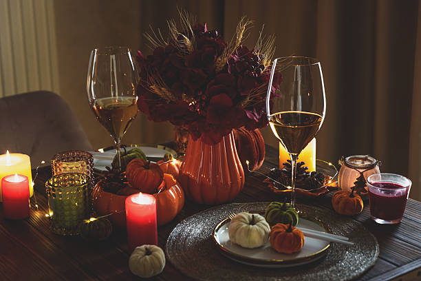 istock Thanksgiving table setting with decorative pumpkins, candles and string lights on dark wooden table 2243770185