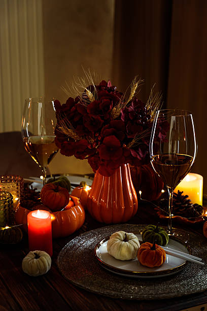 istock Thanksgiving table setting with decorative pumpkins, candles and string lights on dark wooden table 2243770187