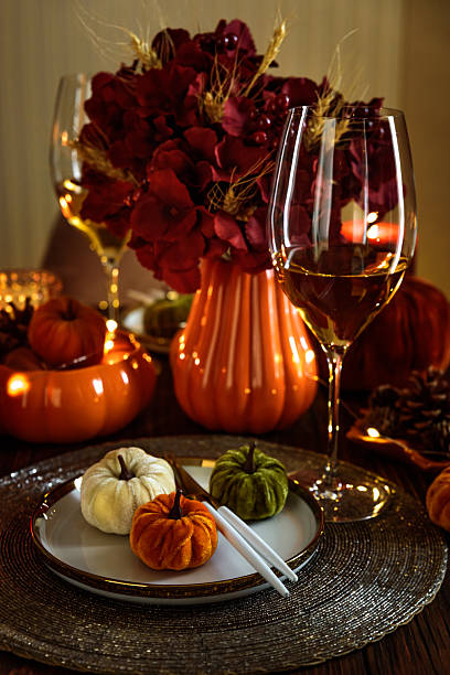 istock Thanksgiving table setting with decorative pumpkins, candles and string lights on dark wooden table 2243770192