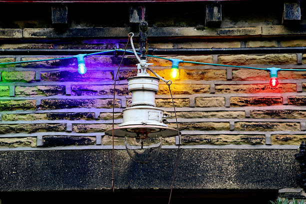 Garden lights in the dark and lanterns in the background.