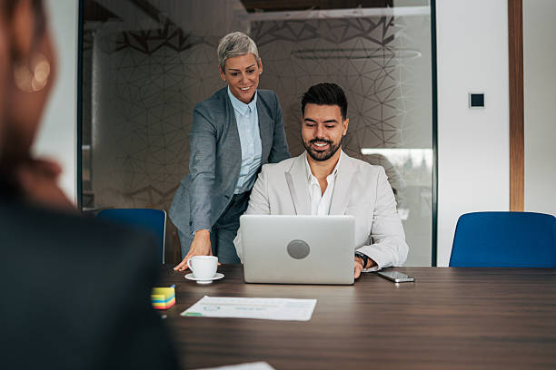 istock Business colleagues collaborating on laptop in office meeting 2243774664
