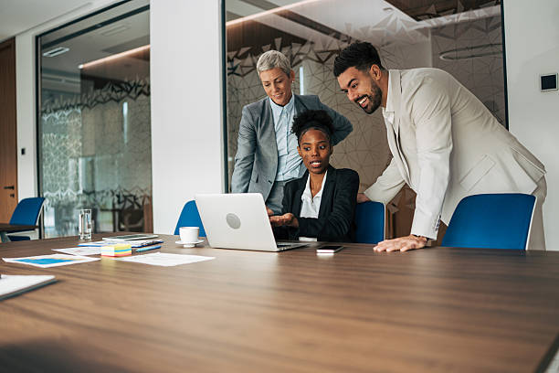istock Business colleagues collaborating on laptop in office meeting 2243774939