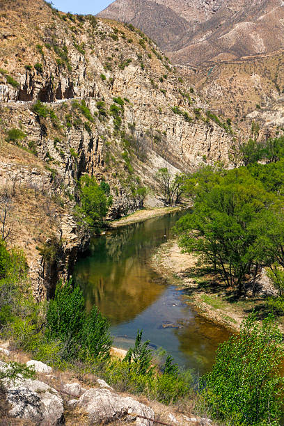 istock Scenic mountain river with clear water flowing through rocky terrain 2243775093