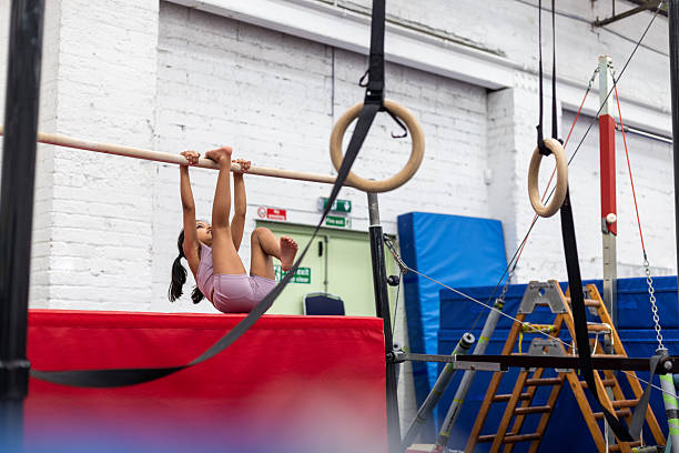 Child gymnast girl doing exercises at gymnasium