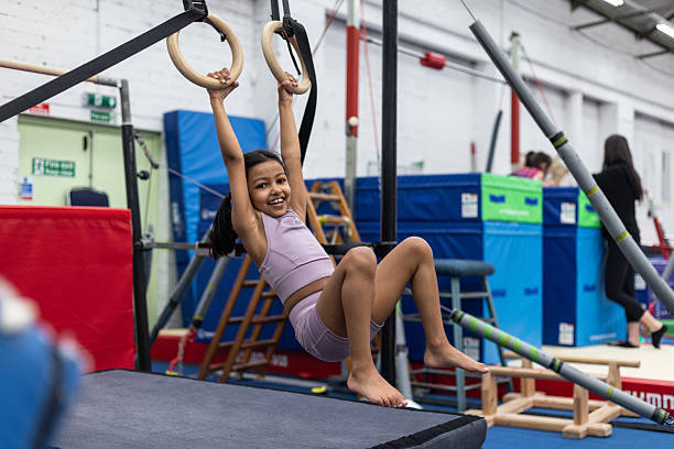 istock Smiling Girl Practicing on Gymnastics Rings 2243775162