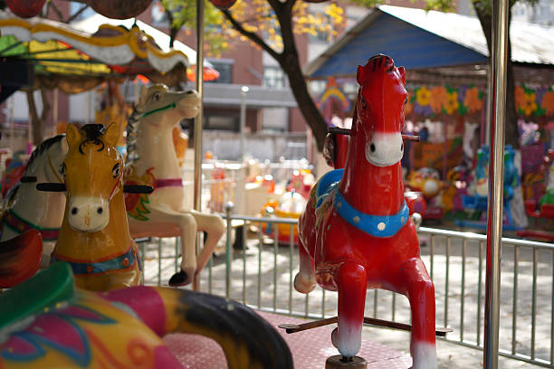 Asian little girl sitting on the rocking horse