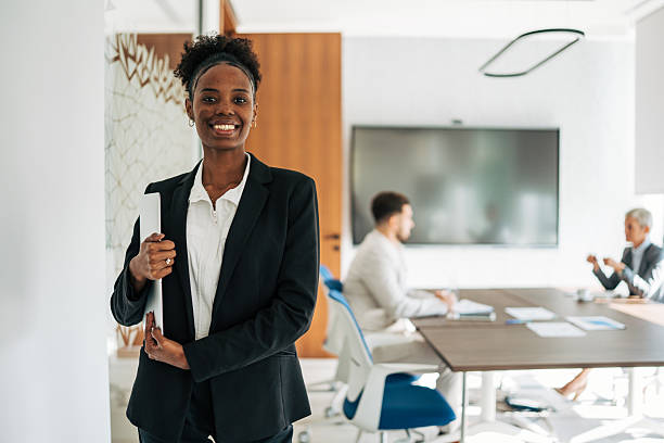 istock Confident businesswoman smiling and holding a folder in modern office 2243776252
