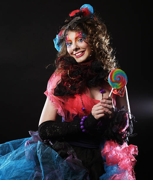 istock Girl with with creative make-up holds lollipop. Doll style. 2243777922