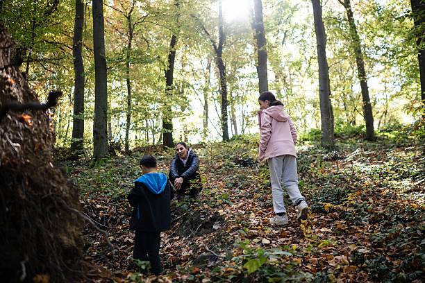 istock Family enjoying autumn nature walk in forest 2243778086