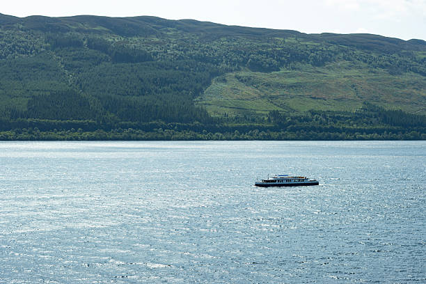 A boat sails across Loch Ness. Scottish landscapes.