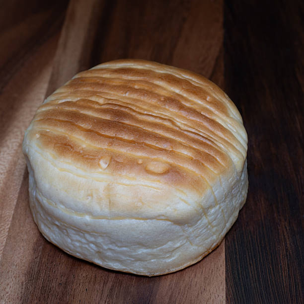 istock Golden cheese bread with a soft, fluffy texture and melted cheese baked into its crust, creating a warm, savory aroma and rich, delicious flavor. 2243781661