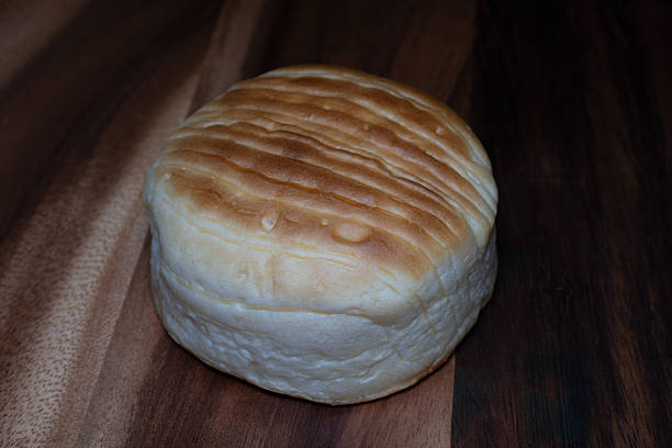 istock Golden cheese bread with a soft, fluffy texture and melted cheese baked into its crust, creating a warm, savory aroma and rich, delicious flavor. 2243781678
