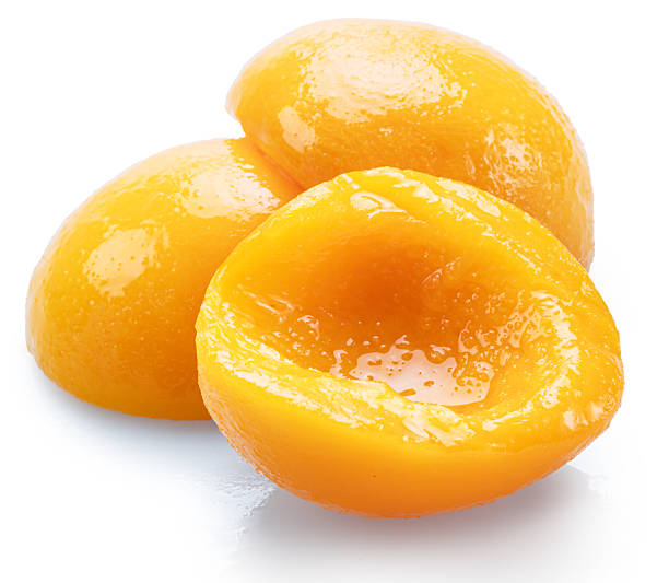 istock Peeled canned peach halves isolated on white background. File contains clipping paths. 2243782196