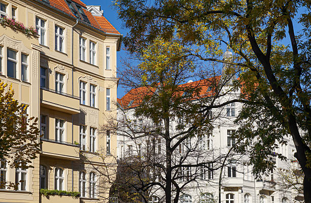 Germany, Berlin, Charlottenburg, October 24, 2025 - Old residential building behind a tree in autumn