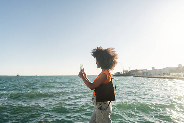 istock Female tourist capturing an image with mobile phone while on a city break vacation 2243783779