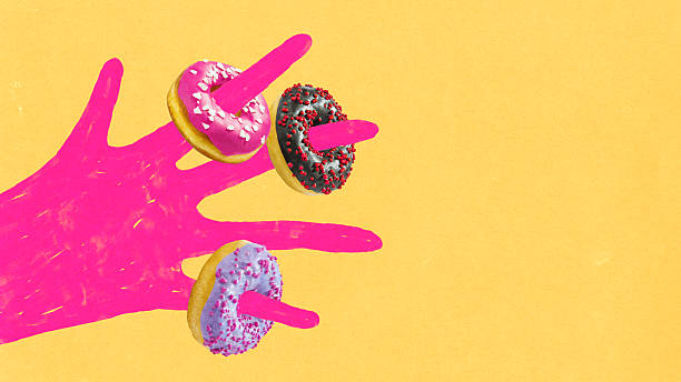 istock Minimalist composition. Pink hand holding colorful sweet donuts on bright yellow background 2243785105