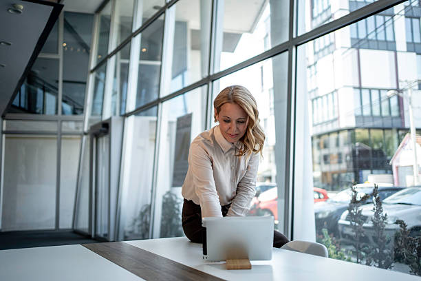 istock Businesswoman working on laptop in modern office 2243785301
