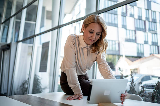 istock Businesswoman using tablet in modern company office 2243785307
