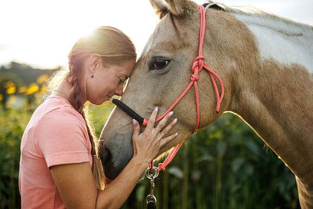 istock Happy woman bonding with her horse 2243786413