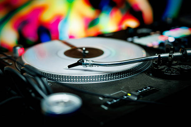 istock Turntable with vinyl record and colorful lights 2243788571